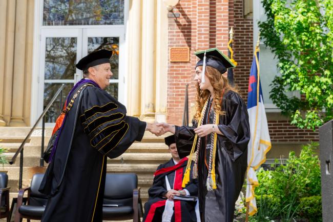 Valedictorian Abigail Speer shaking hands with President Douglas G. Lee at Commencement