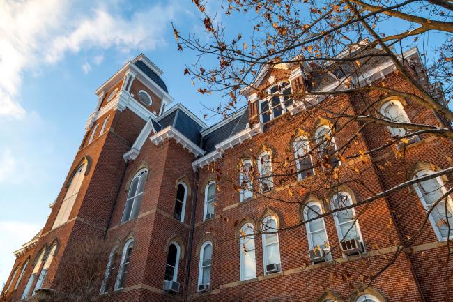 Low angle shot of Miller Hall with a blue sky and wispy white clouds