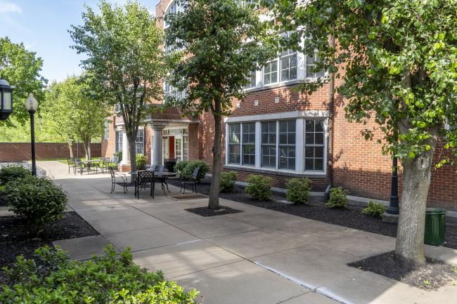 East Hall exterior, including sidewalk and trees, on a sunny day