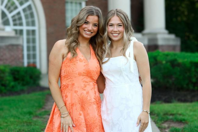 Olivia and Emma post together in front of Stover Campus Center.